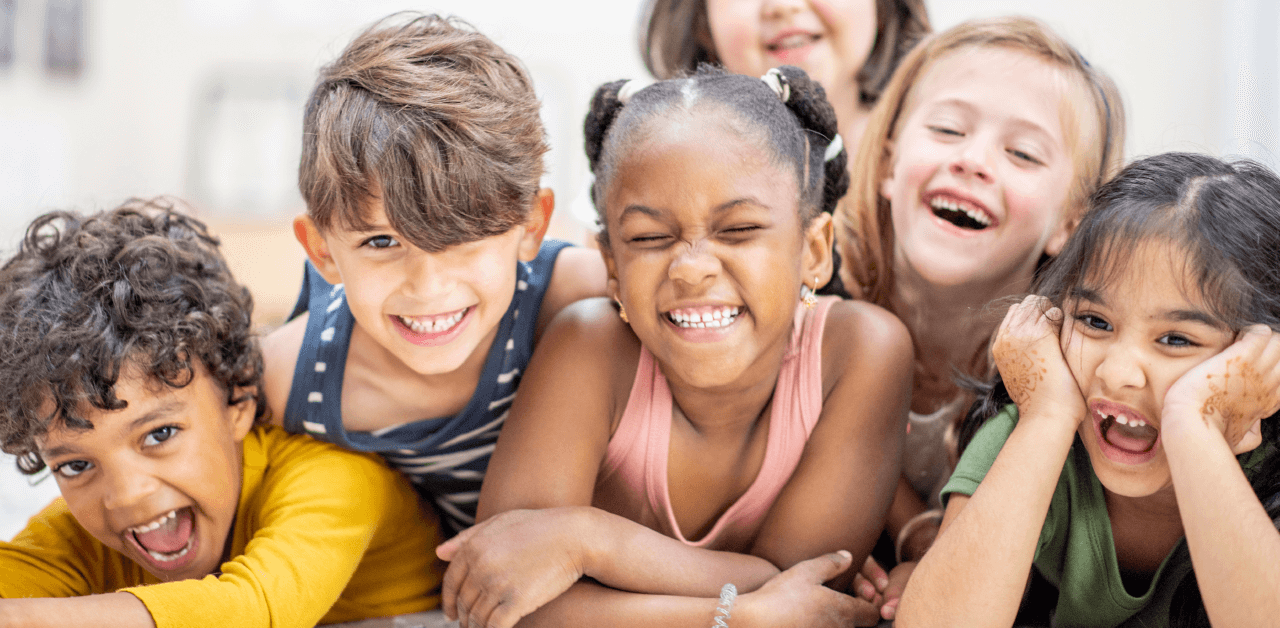 A joyful group of children laughing and smiling together, capturing a moment of happiness and camaraderie.