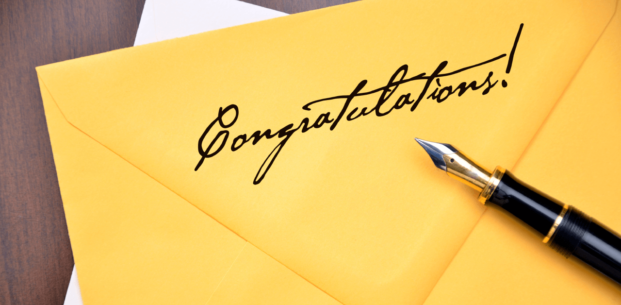 A yellow envelope with the words 'Congratulations' written on it.