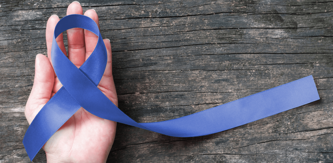 An individual displays a blue ribbon in their hand.