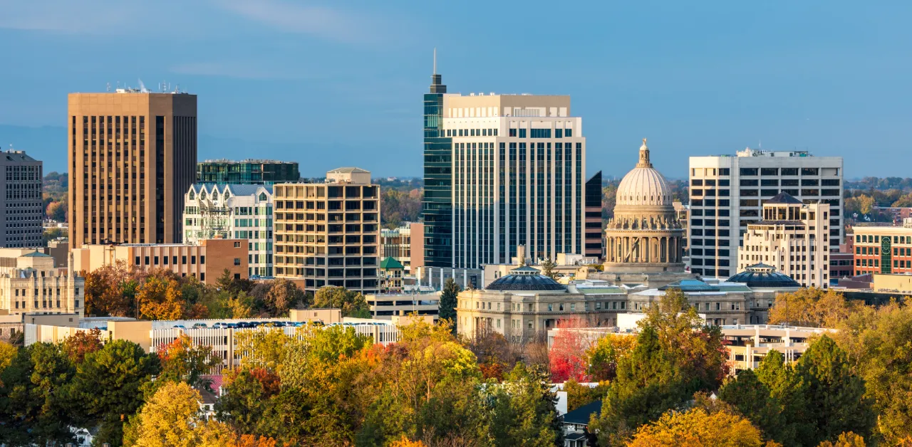 The sun shines on the Boise, Idaho skyline, with the State Capitol in view.