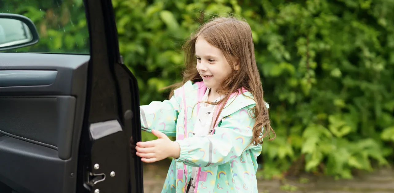 Smiling student getting into a car safely, representing modern and equitable charter school transportation solutions