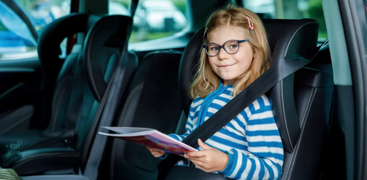 Young student riding safely in a small-capacity vehicle, representing flexible and reliable charter school transportation.