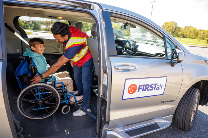 A student in a wheelchair being secured in a FirstAlt van. (Photo courtesy of First Student.)