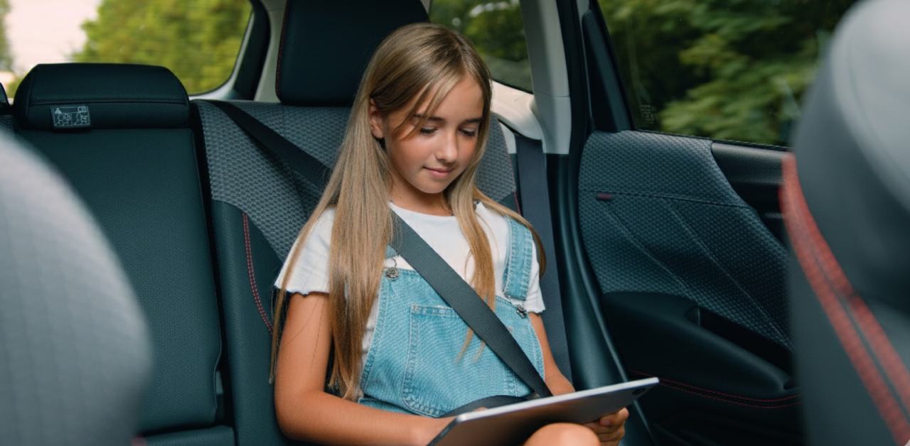 student wearing a seat belt while riding in the back seat