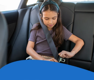 A young girl fastens her seatbelt in a car's back seat. The text "Modern Student Transportation and Your Child" overlays the image, conveying safety.