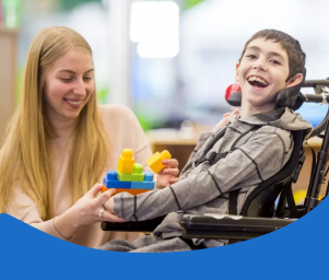 A teacher assists a smiling student in a wheelchair with building blocks, conveying warmth and support. Text: "Students on an IEP or 504 Plan."