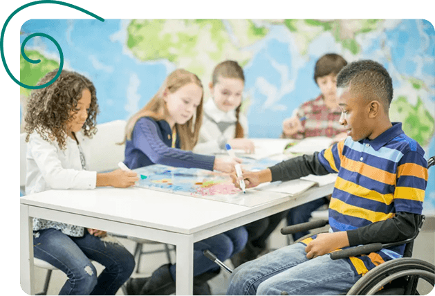 Children studying together at a table with a globe in a classroom.