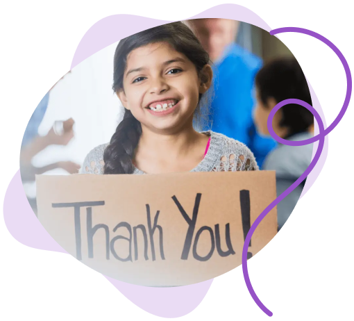 A young girl holding up a hand written sign saying "Thank You"